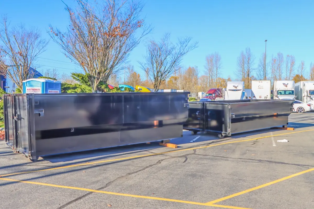 Professional dumpster rental service with roll-off container on residential driveway in Clarcona